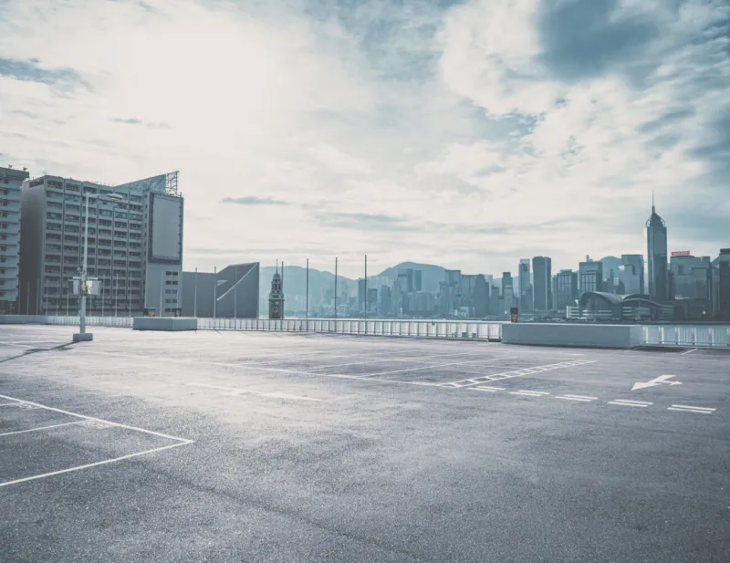 Large flat commercial rooftop with a city skyline behind