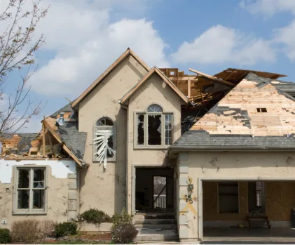 House with roof torn open by storm damage